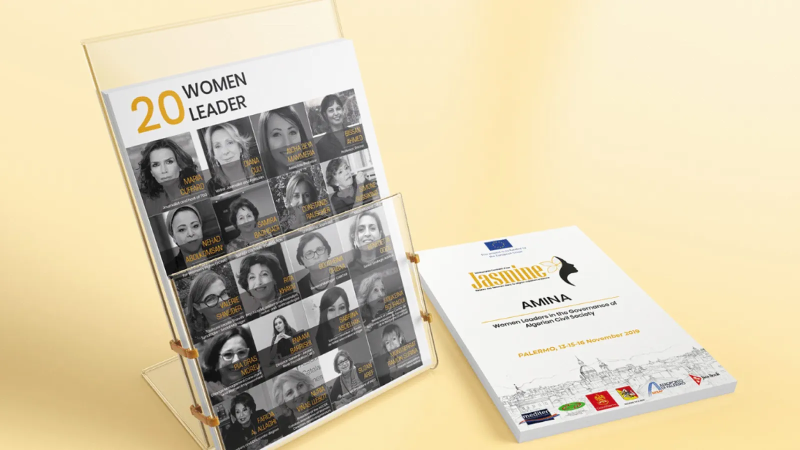 A display stand holding the “20 Women Leaders” publication with portraits, beside an AMINA brochure
